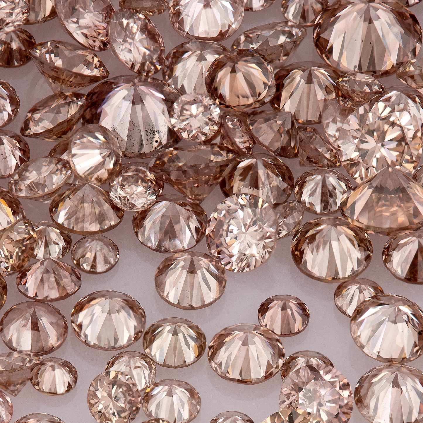Fancy Intense Pink Champagne PC1/2 | Argyle Pink Diamonds Select | Chocolate Argyle Pink Diamond | Untreated Natural Pink Diamond | Round Melee Accents