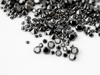 Representative natural black round brilliant diamond melee in mixed face-up and reverse views; color enhanced.