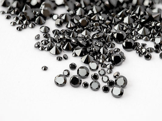 Representative natural black round brilliant diamond melee in mixed face-up and reverse views; color enhanced.