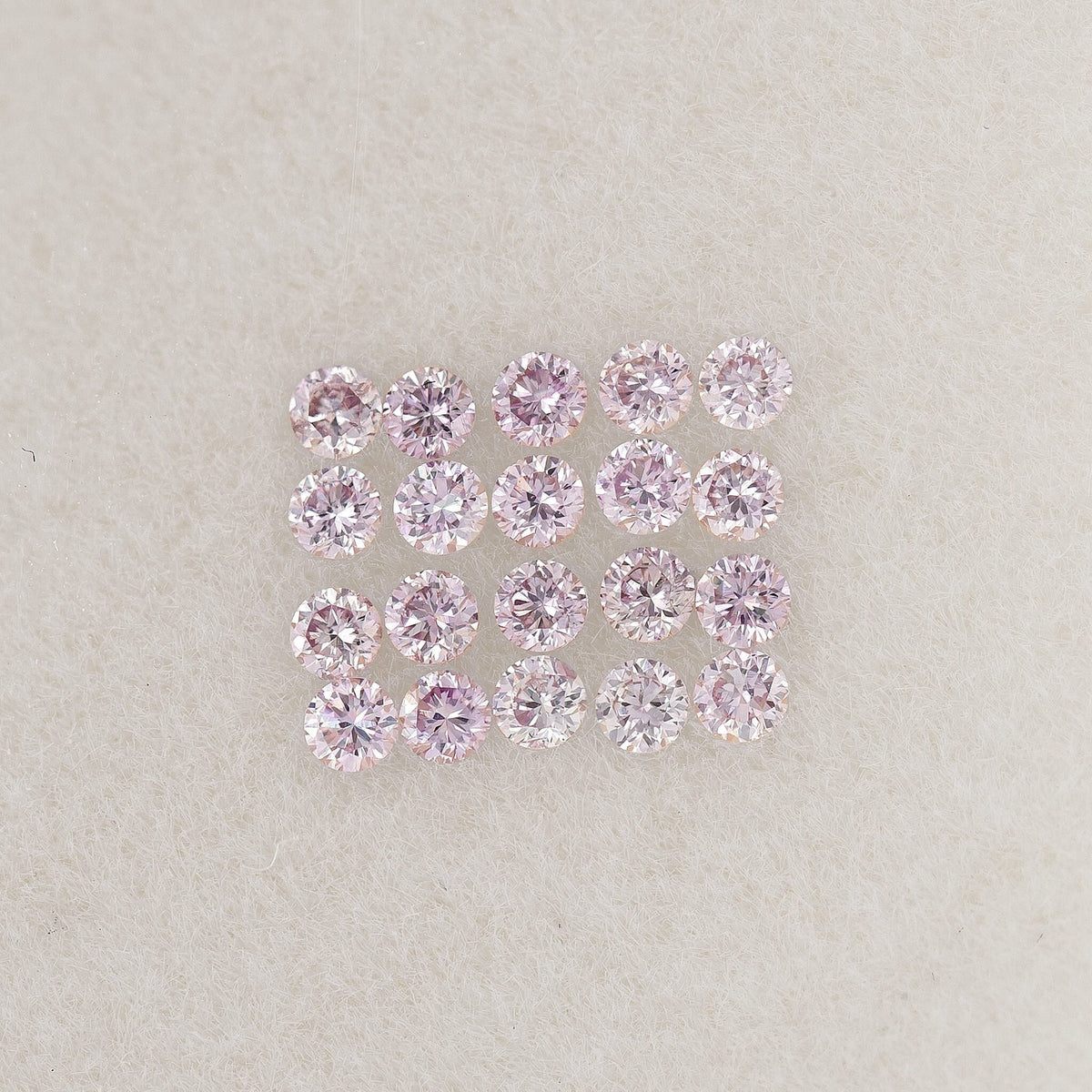 Representative 1mm purple-pink round diamonds arranged in a grid to show color and matching.