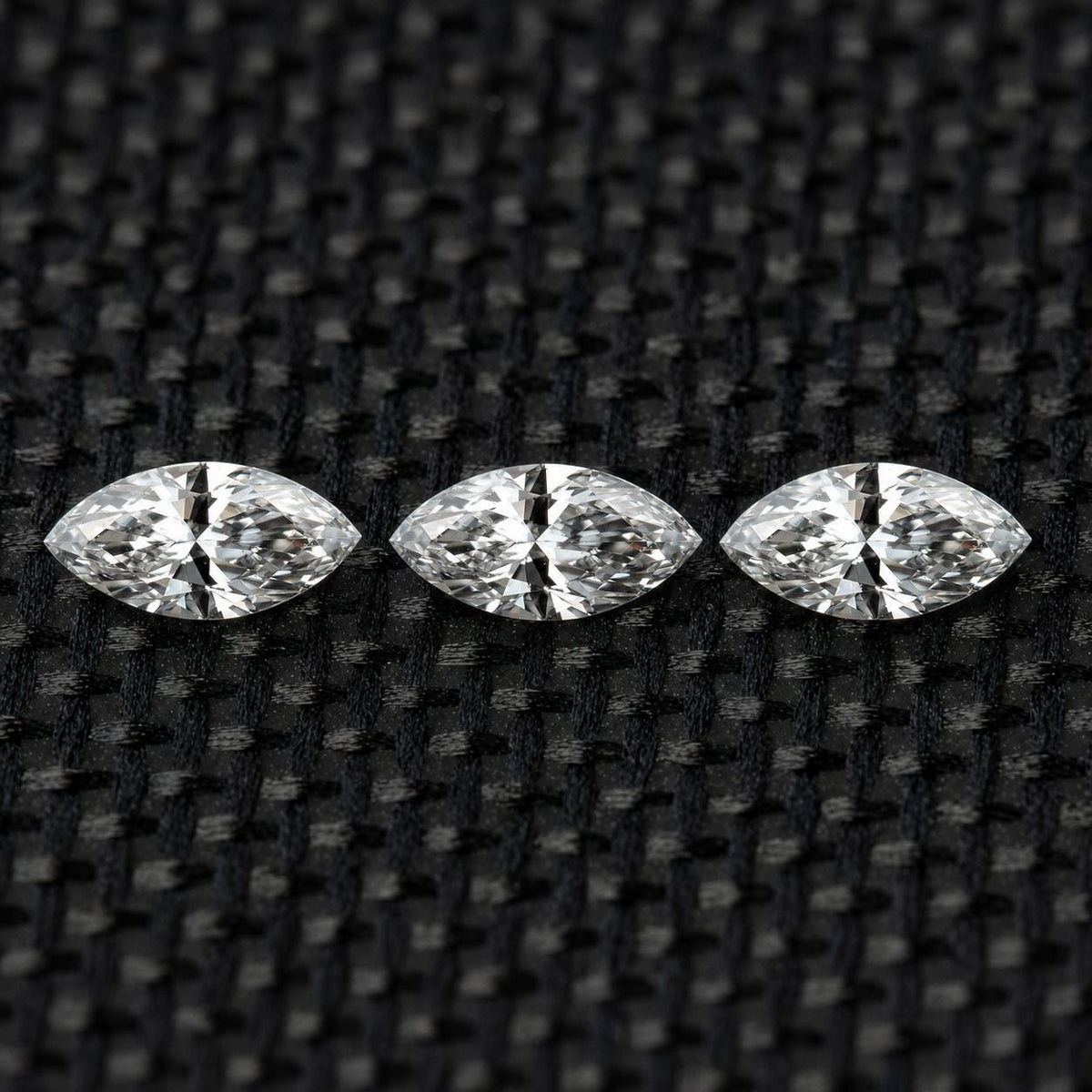 Three matched 4 x 2 mm natural marquise diamonds arranged in a row.