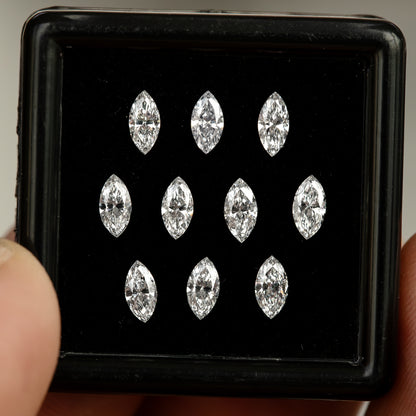 Front close-up of ten face-up marquise diamonds in a black display box, illustrating consistency of outline.