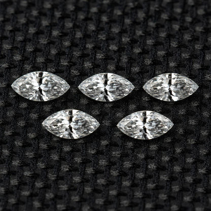 Five matched 4 x 2 mm natural marquise diamonds arranged as a set.