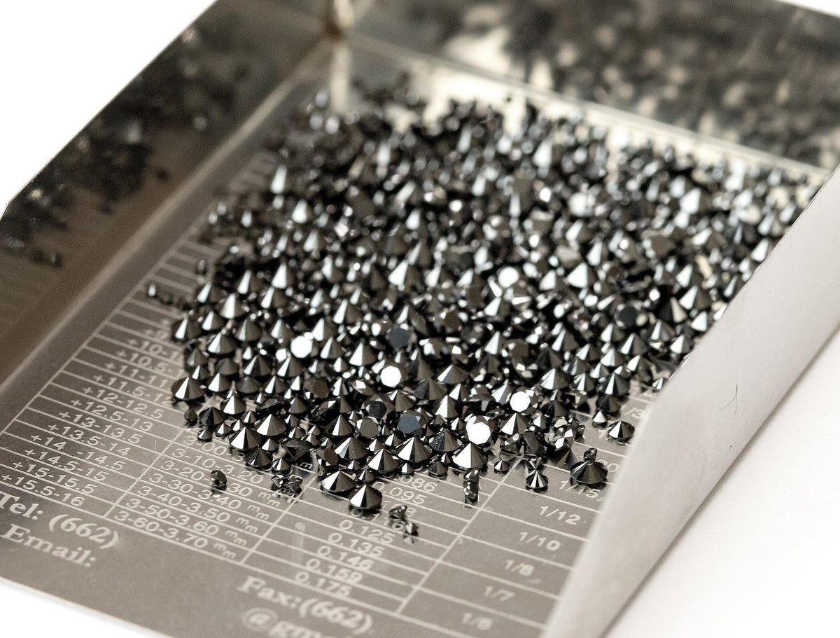 Angled tray view of representative natural black diamond melee; not every selectable size is shown.