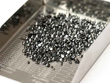 Angled tray view of representative natural black diamond melee; not every selectable size is shown.