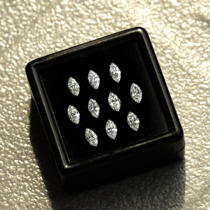 Black box containing ten marquise diamonds on a pale textured surface; reference parcel, not a ten-piece sale option.