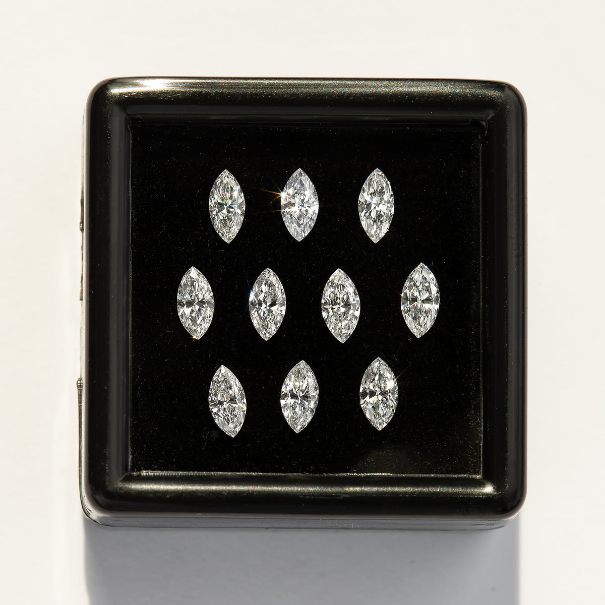 Straight-on black display box with ten white marquise diamonds on a pale background; quantity is chosen separately.