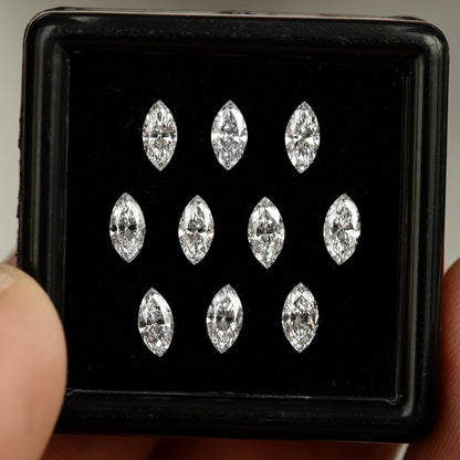 Front view of calibrated natural marquise diamonds arranged in a gem box.