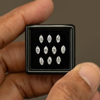 Ten-diamond marquise display box held upright between a thumb and finger for a scale comparison.