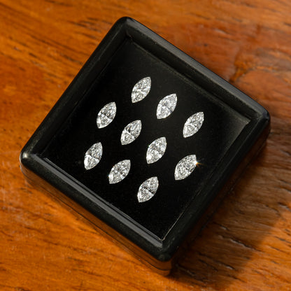 Diagonal display box of marquise diamonds on wood, showing an alternate arrangement of reflections.