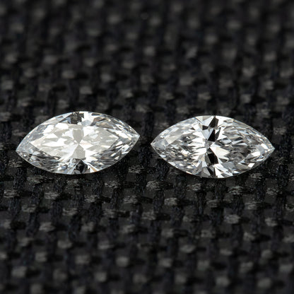 Two face-up marquise diamonds side by side on black woven fabric, illustrating the matched-pair selection.