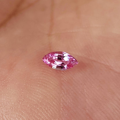 Alternate palm view of the marquise sapphire with bright reflections on the upper facets.