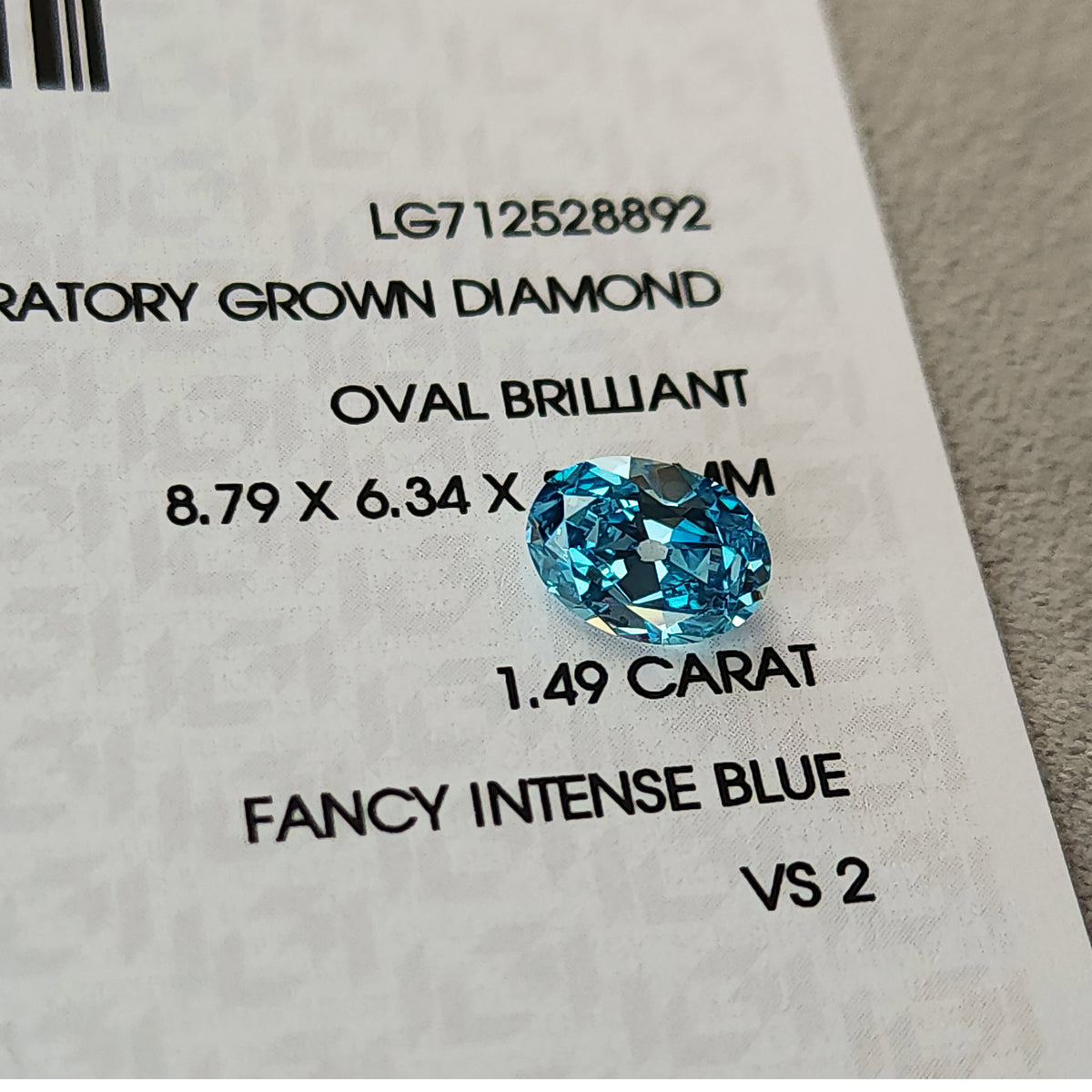 Blue oval diamond on its IGI report showing LG712528892, 1.49 carat, Fancy Intense Blue and VS2.