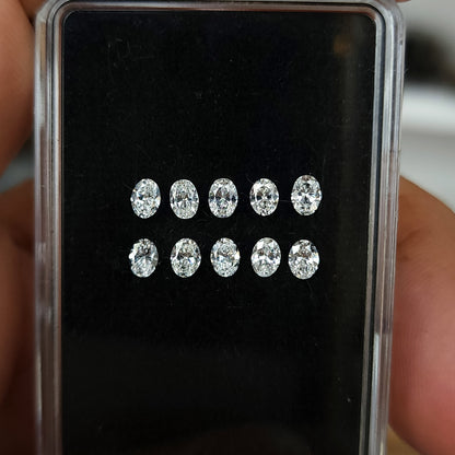 Display box containing ten oval brilliant diamonds arranged in two rows.