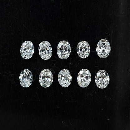Ten oval brilliant diamonds arranged face-up in two rows on black backing.