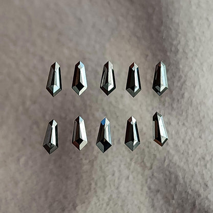 Two rows of five black shield diamonds on gray paper as a calibrated-stock reference; purchase unit is one diamond.