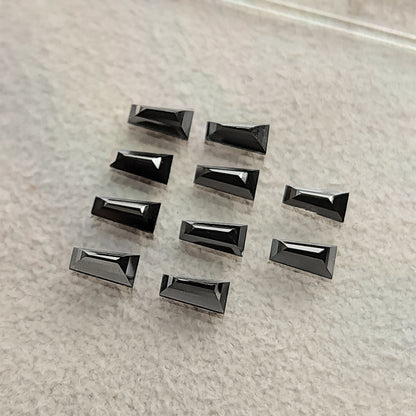 A loose group of black tapered diamonds viewed at an oblique angle.