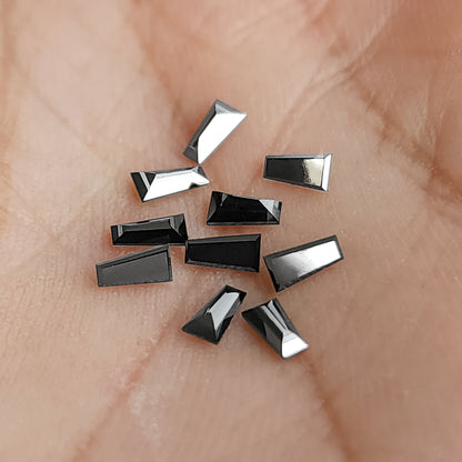 A second palm view of the black tapered diamonds, showing their narrow trapezoid outlines.