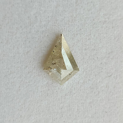 Face-up view of the 0.92 ct kite-shaped natural diamond, showing rose-cut facets, visible inclusions and pale warm gray reflections.