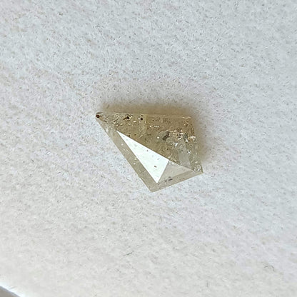 Tilted view of the kite rose-cut diamond, with changing reflections across its broad facets.