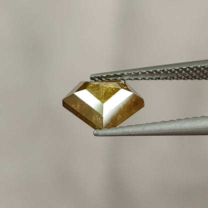 Low tilted profile view of the two-sided shield diamond, showing its depth and polished edge rather than a full face-up outline.