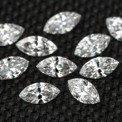 Rows of marquise diamonds in a close face-up layout, showing differences in bright and dark facet reflections.
