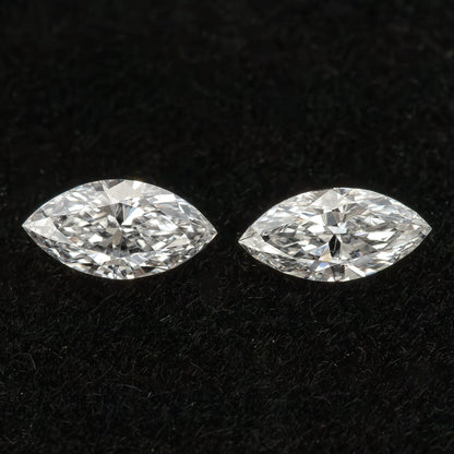 Two marquise diamonds separated on black velvet, illustrating a pair rather than a larger parcel.