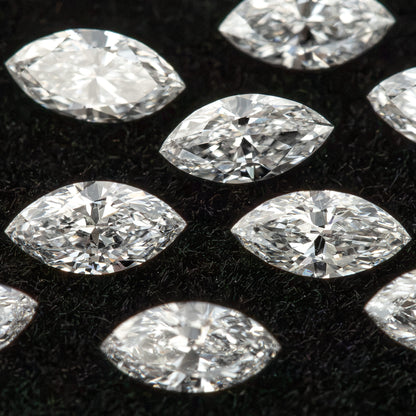 Tightly framed group of marquise diamonds on dark velvet, with several stones partly outside the frame.