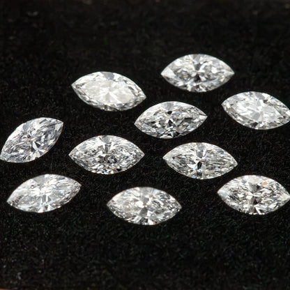 Ten white marquise diamonds spread across black velvet as a reference for the calibrated supply.