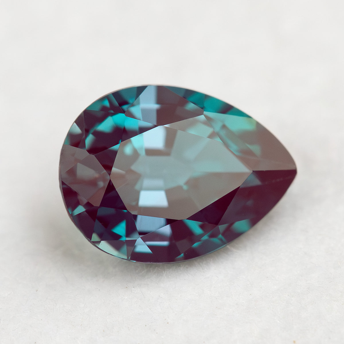 Angled crown view of the pear sample with broad pale reflections across the table.