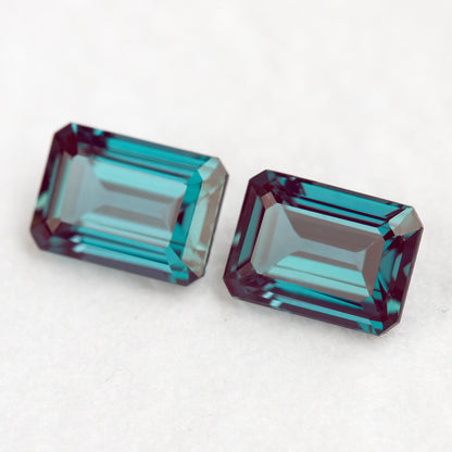 Two emerald-cut samples side by side on a pale surface, illustrating a pair layout.