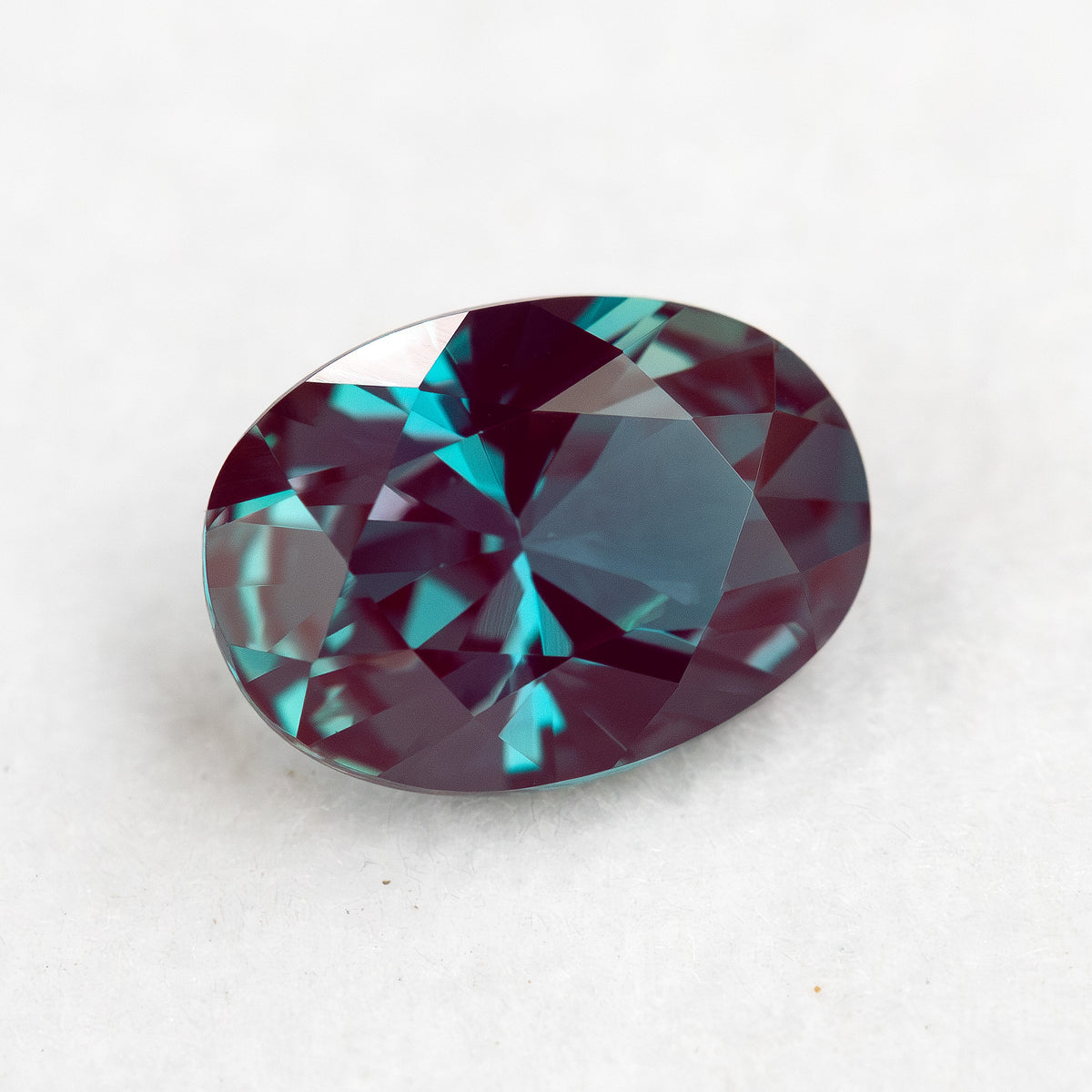 Oval sample shown face-up at a different angle to reveal its crown facet pattern.