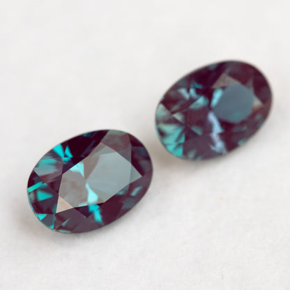 Two oval samples arranged diagonally, with the rear stone softly focused.