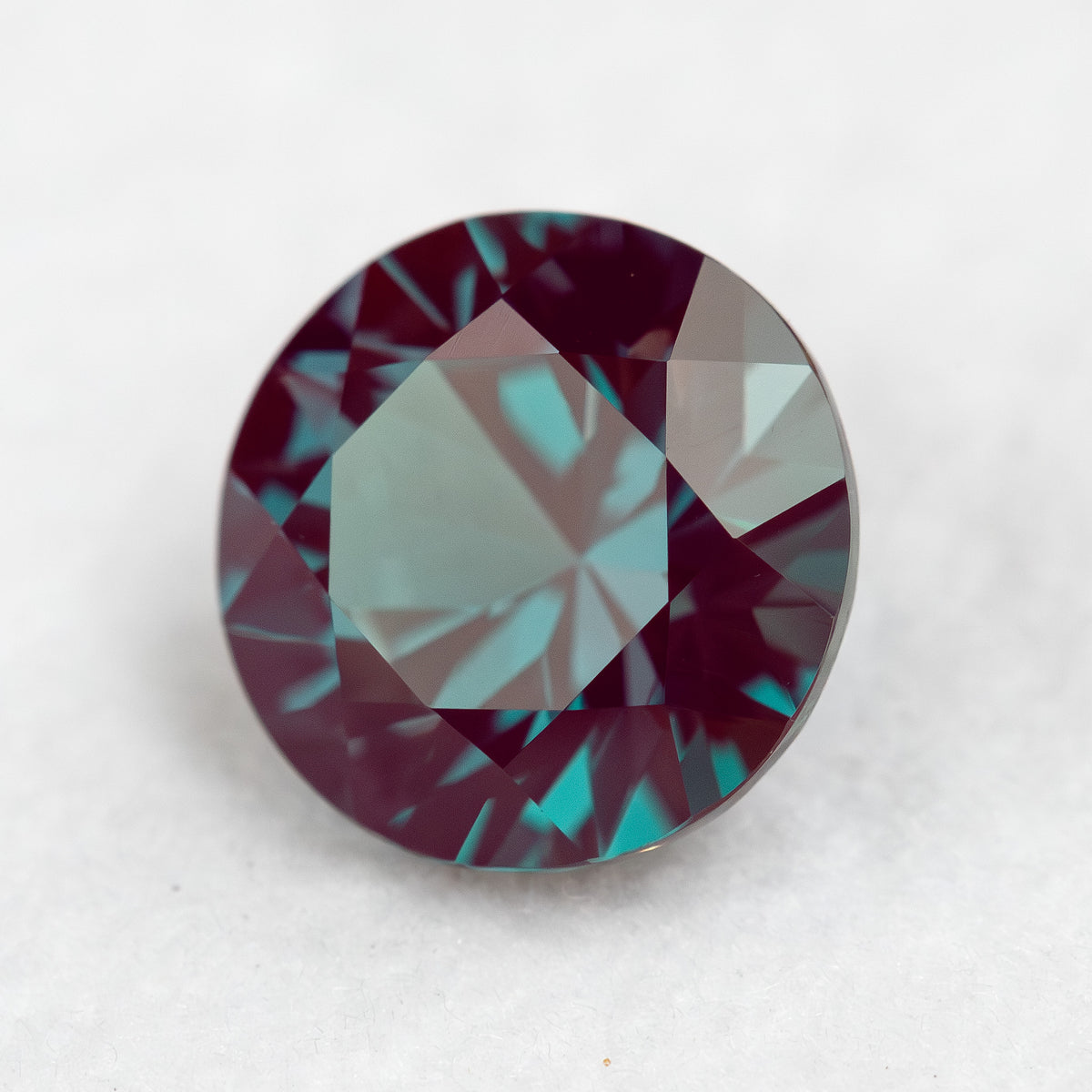 Another tilted round sample view, showing its circular outline and crown reflections.