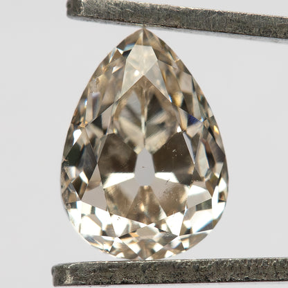 Face-up view of the pear-cut diamond held vertically in tweezers, showing the full outline and antique-style facets.