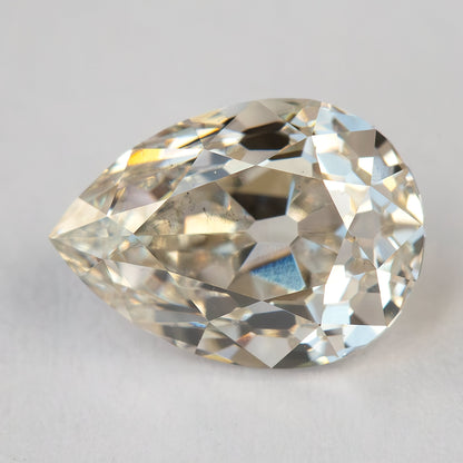 Alternate face-up view of the loose pear diamond on a light background, showing its antique-style facet pattern.