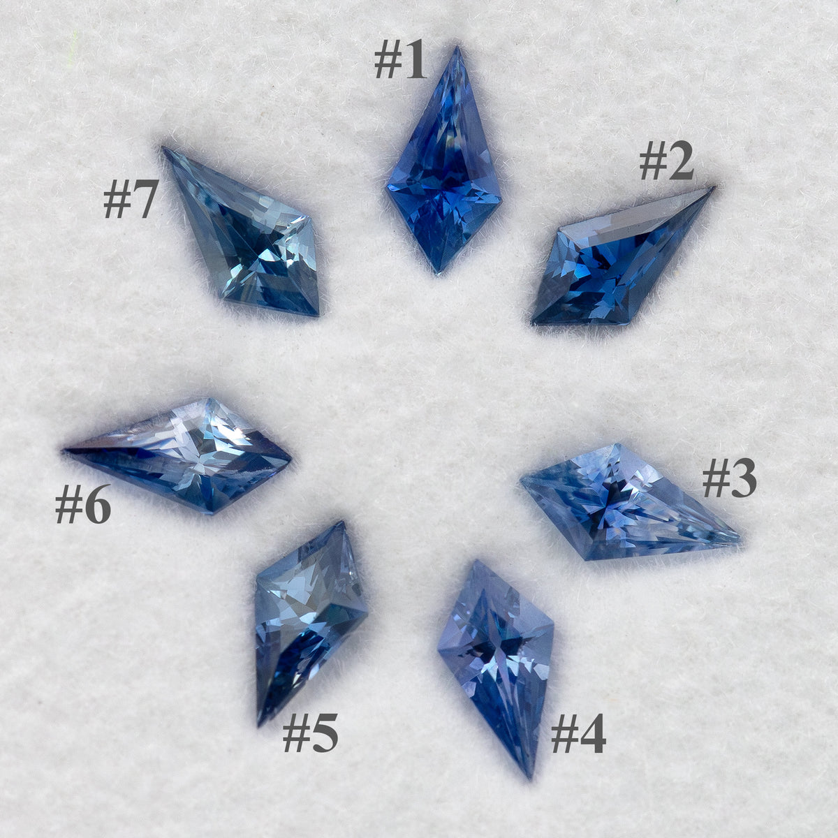 Seven blue kite-shaped sapphires labeled 1 through 7, identifying the original parcel stones.