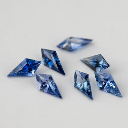 The blue sapphire parcel from a diagonal angle, showing the complete pointed outlines of the foreground stones.