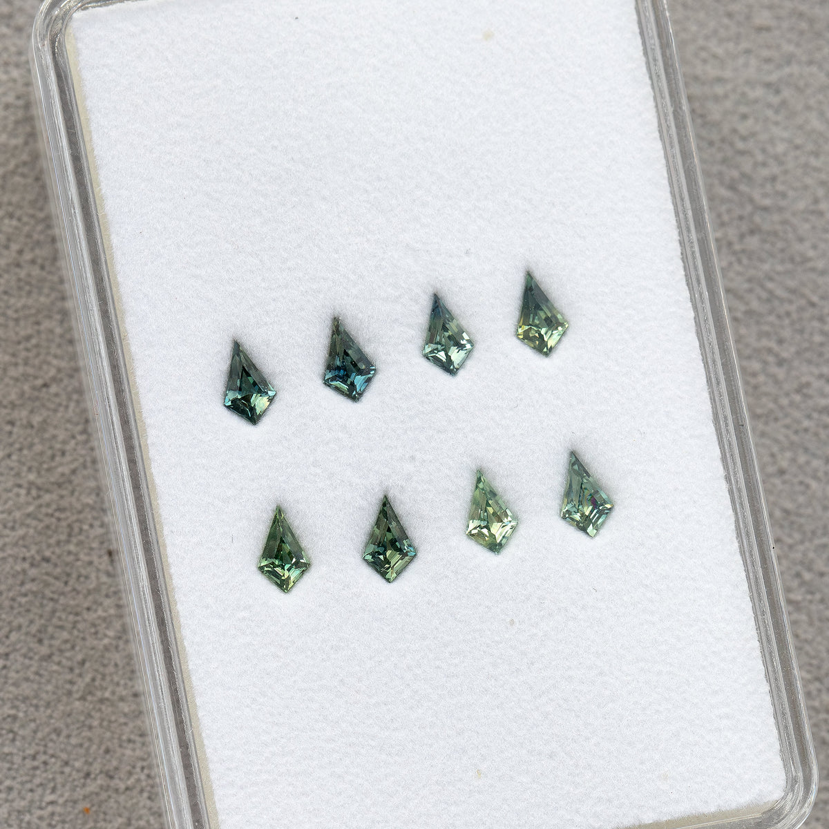 Original group of kite sapphires in a clear tray, showing spacing and size.