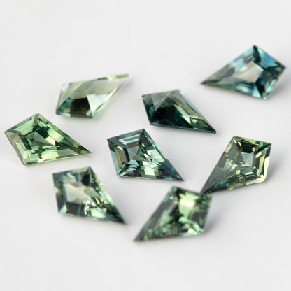 A second close view of the green and teal sapphires at an oblique angle.