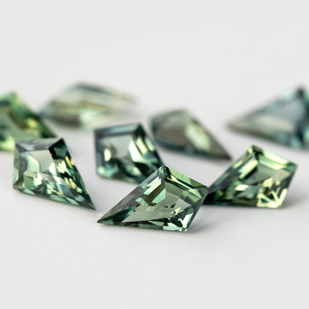 Very low-angle view of the sapphire group, with the nearest crown facets in focus.