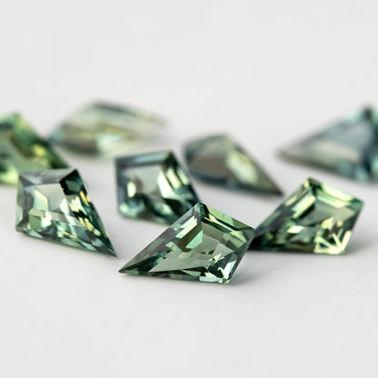 Very low-angle view of the sapphire group, with the nearest crown facets in focus.
