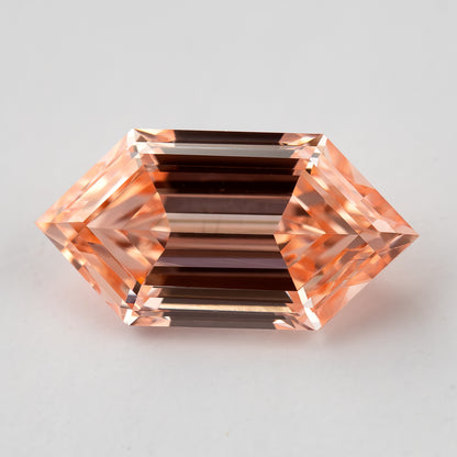 Face-up table-side view of the exact 0.77 ct peach pinkish orange lab-grown diamond in an elongated Dutch marquise hexagon shape.