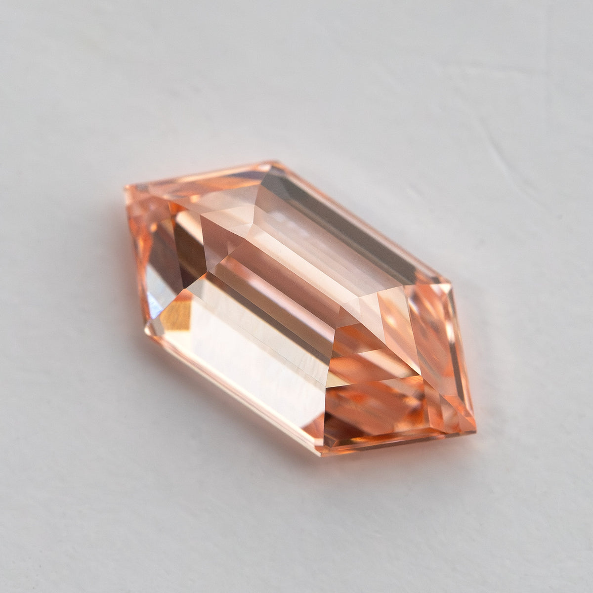 Oblique side view showing the diamond's pavilion, crown and elongated step-cut construction.