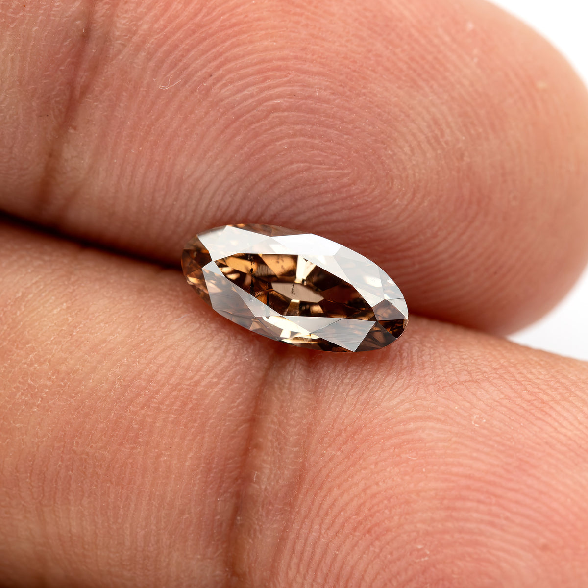 1.43 ct pinkish-brown lab-grown elongated oval diamond, finger side scale, SKU BLD154