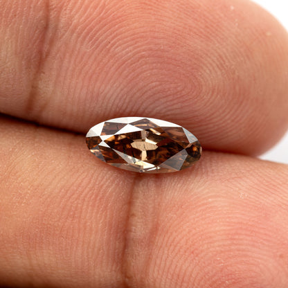 1.43 ct pinkish-brown lab-grown elongated oval diamond, finger face-up scale, SKU BLD154