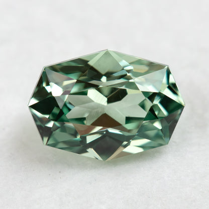 Face-up BLS111 mint green lab-grown sapphire on a white background, showing its geometric fancy cut.