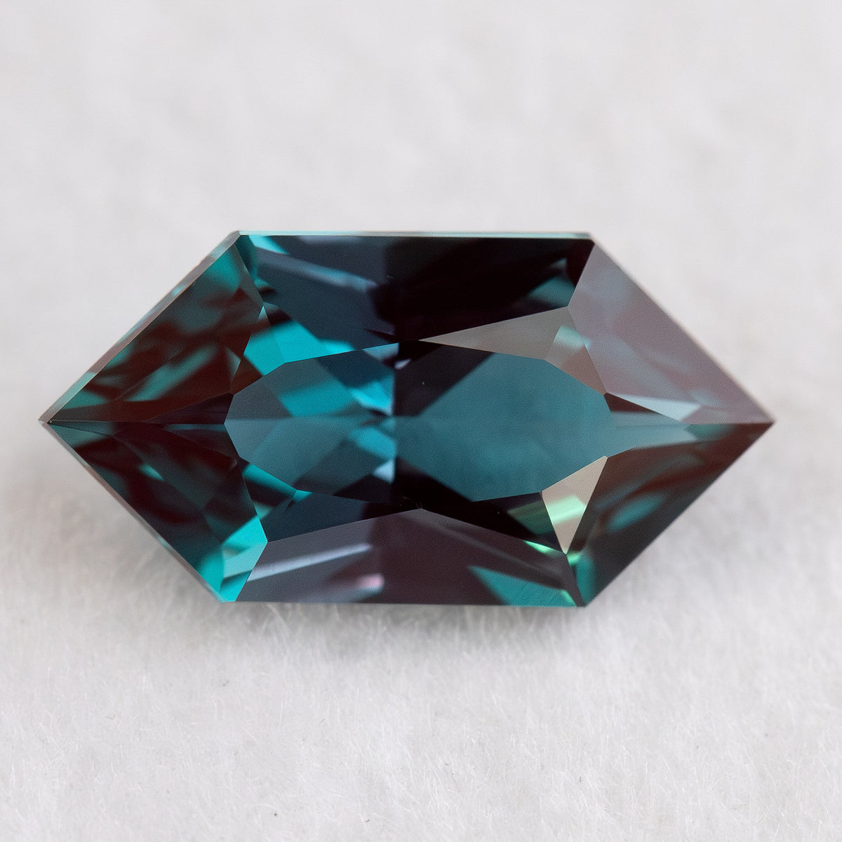 Face-up BLS113 lab-grown alexandrite on a white background, showing the Dutch Marquise Hexagon facet pattern.