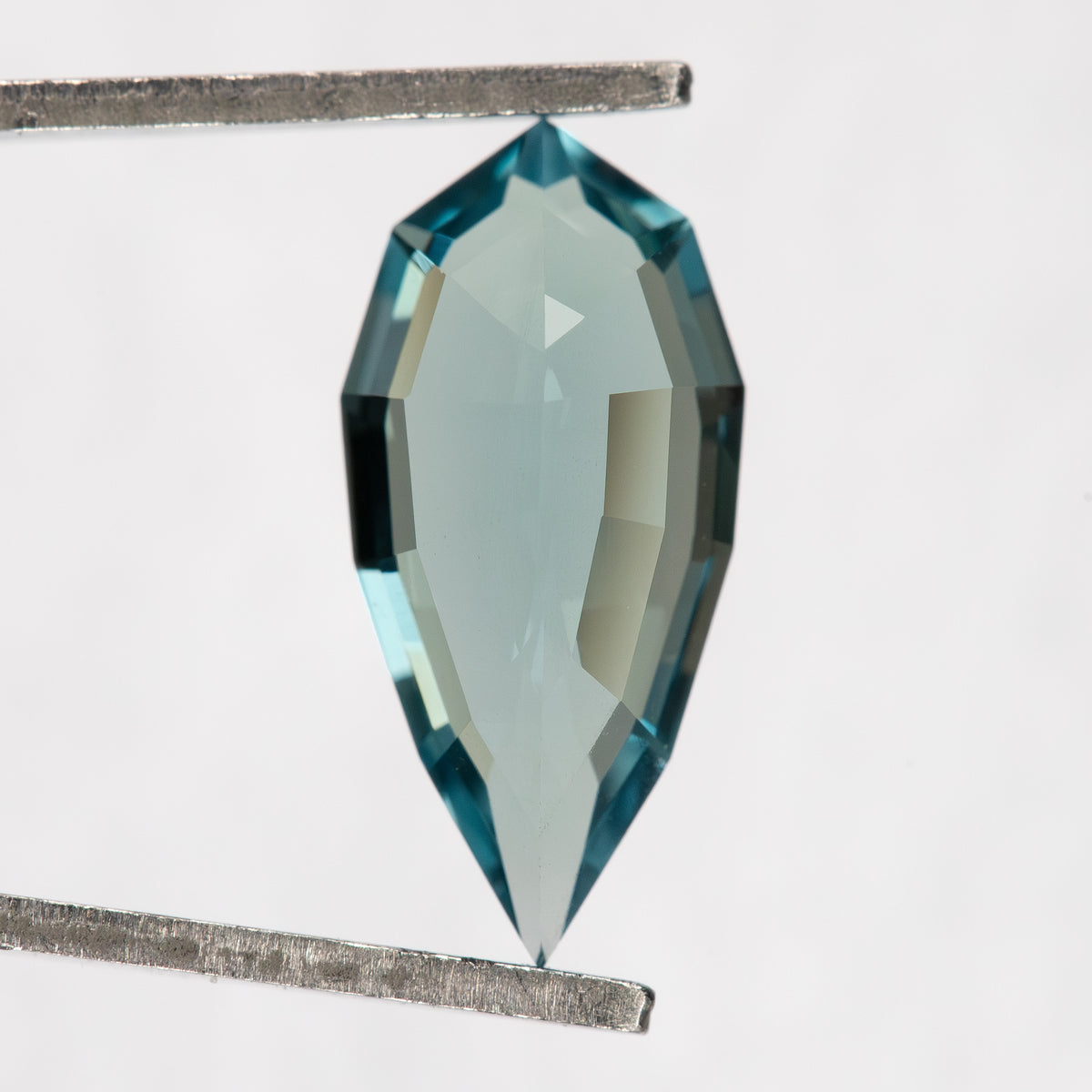 Rear view of one BLS114 elongated pear lab-grown sapphire.