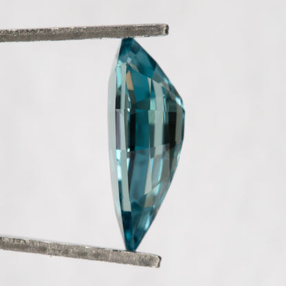 Side profile of one BLS114 elongated pear sapphire showing its faceted depth.